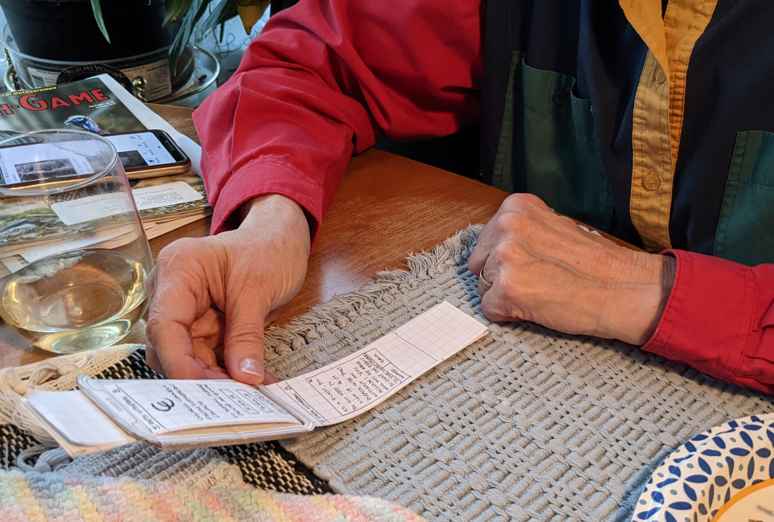 User 1 testing the second iteration of the paper prototype of "ChurchConnect".